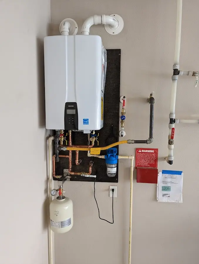 Professional plumber installing copper piping in a Calumet Park home